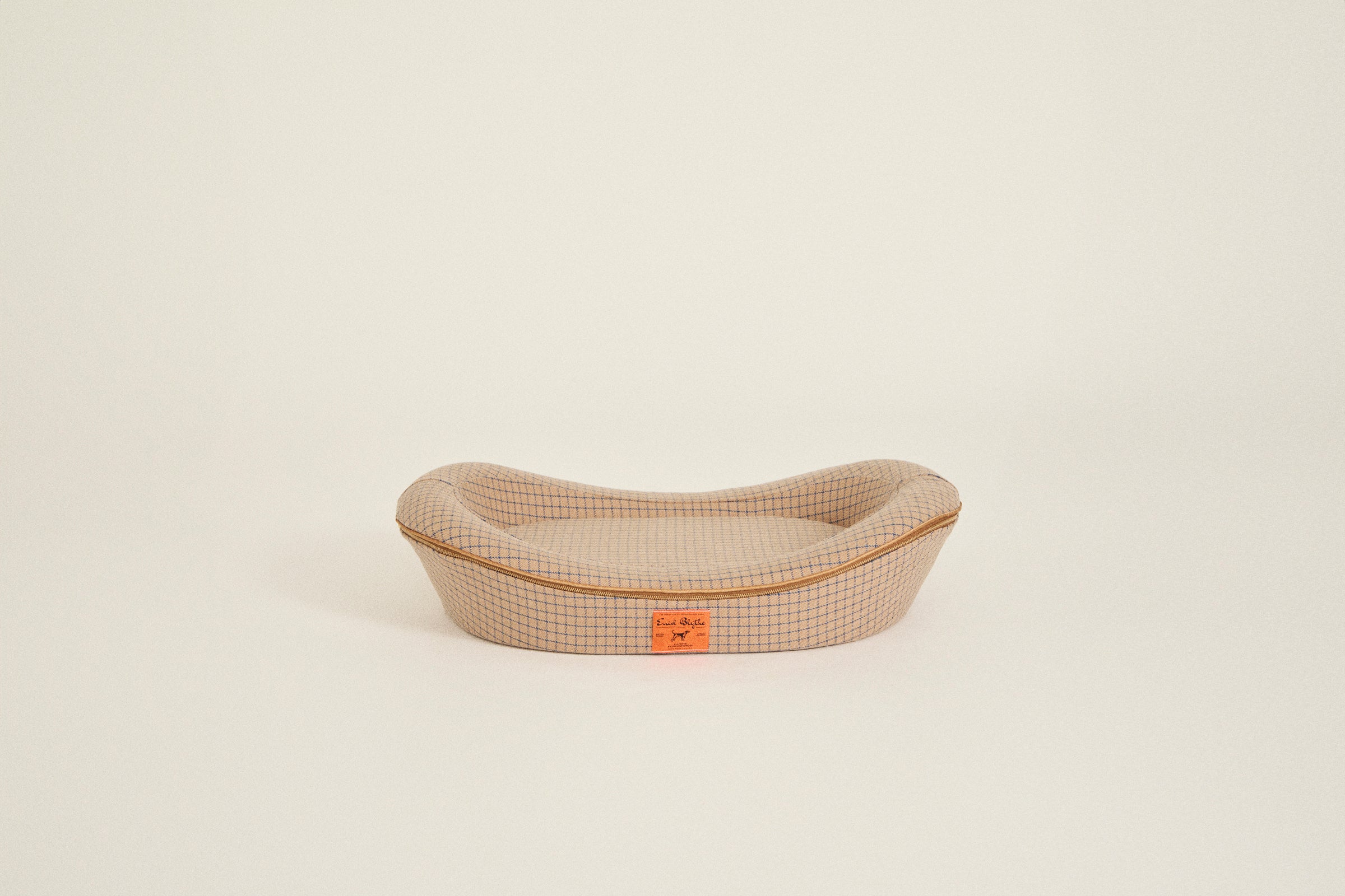 Best dog beds for small dogs. Brown color with an orange label.
