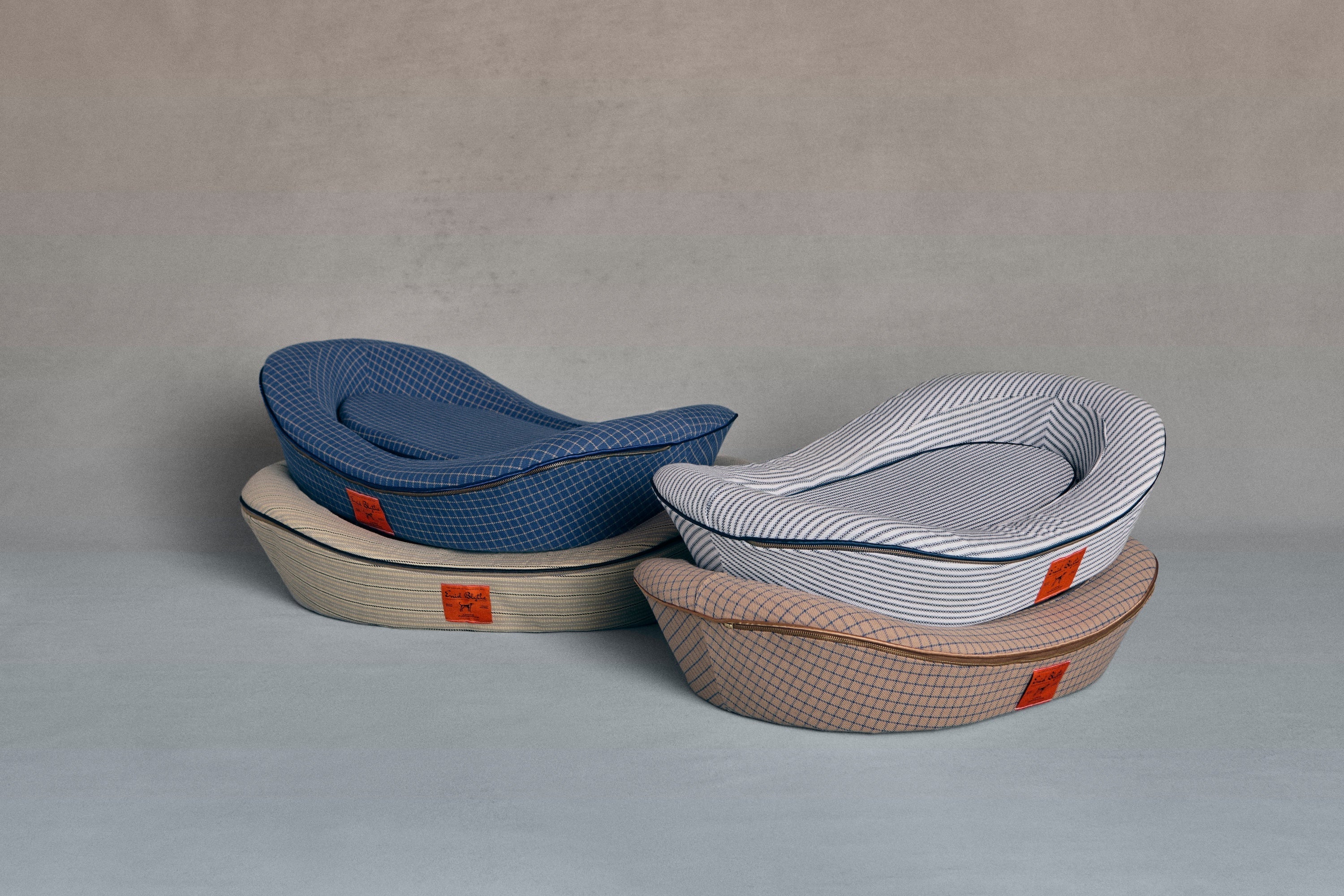 Enid Blythe luxury dog beds stacked up in four colors